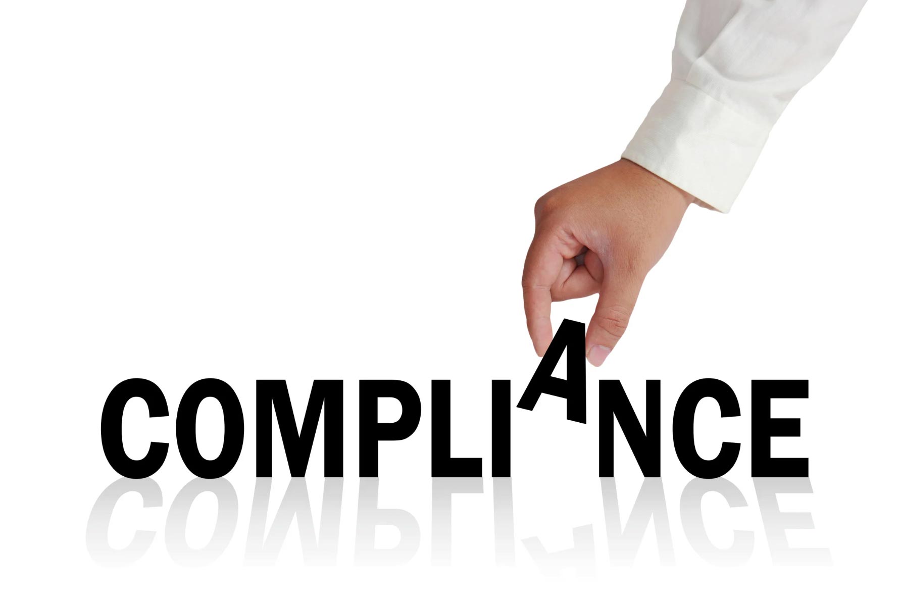 A hand places the letter “A” in the word “COMPLIANCE” on a white background with reflections.